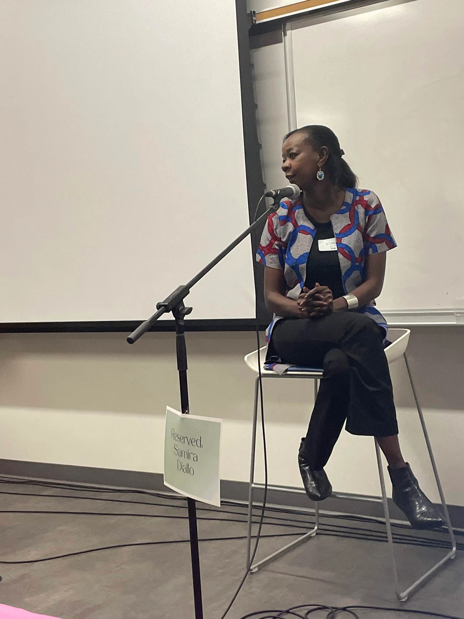 Samira Diallo speaking at a podium